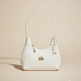 White Coach Handbag with Gold Logo